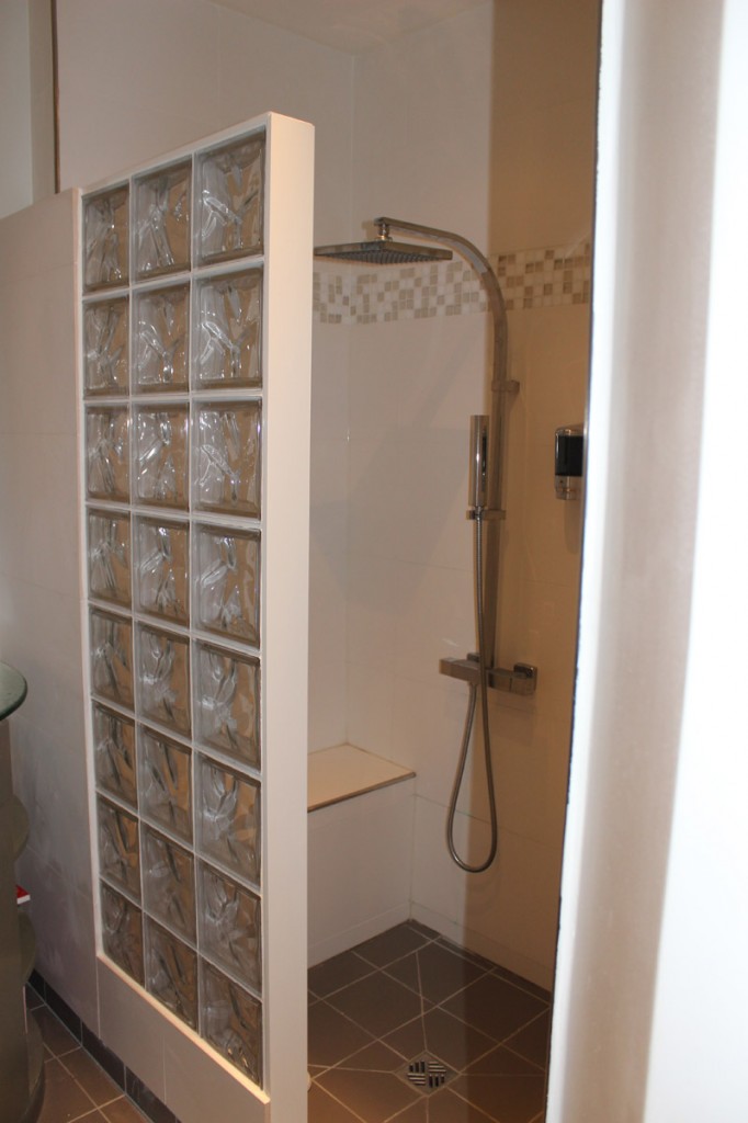 Shower stall with glass block wall.
